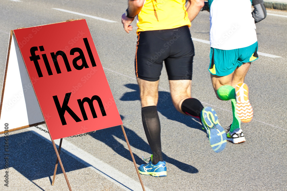 Two runners are running the last kilometer - concept image