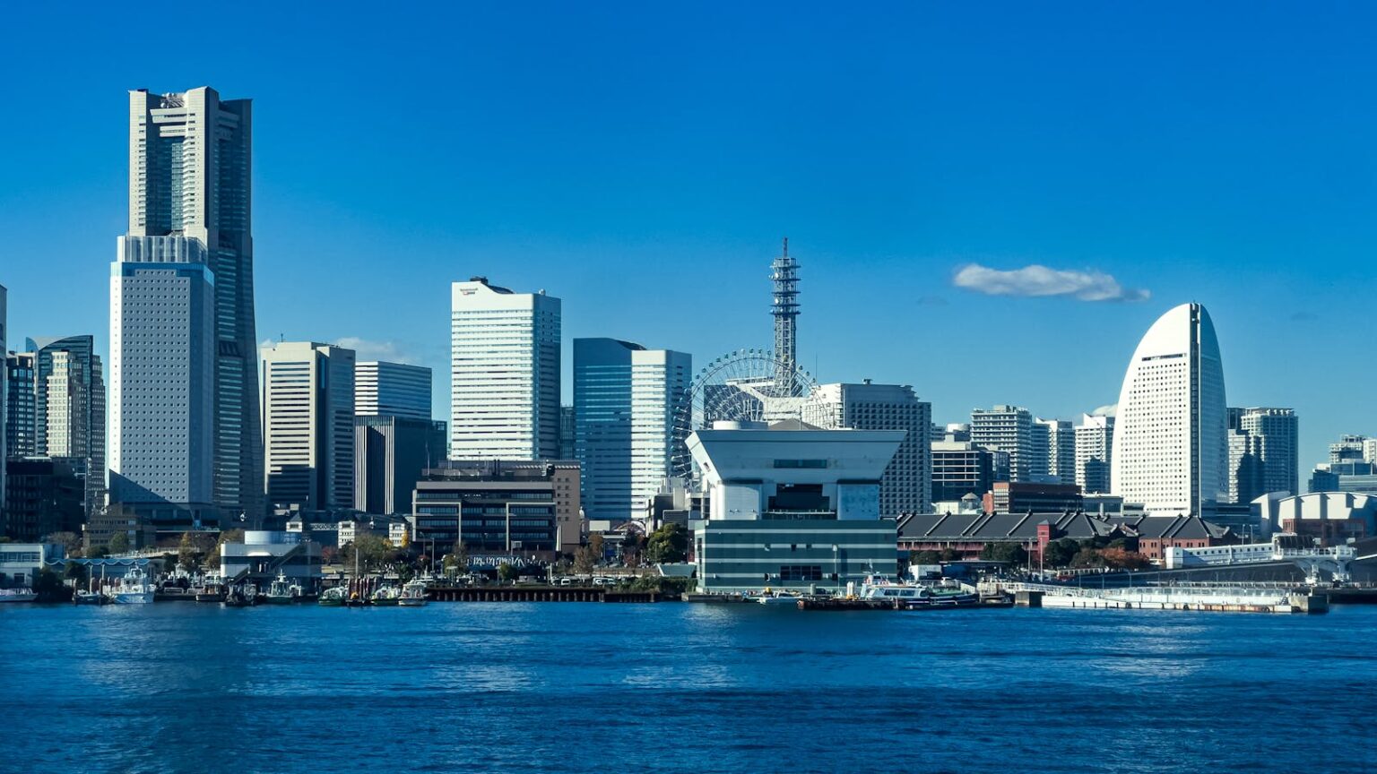Explore the stunning Yokohama skyline with modern skyscrapers and a vibrant urban harbor view.