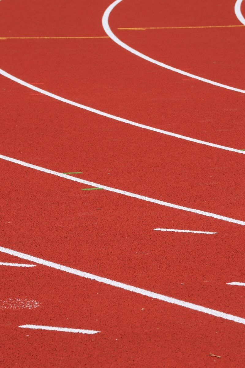a red running track with white lines on it